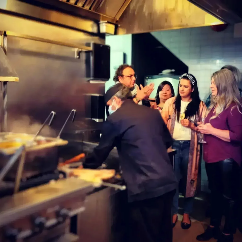 chef vikram with guests looking at the tandoor