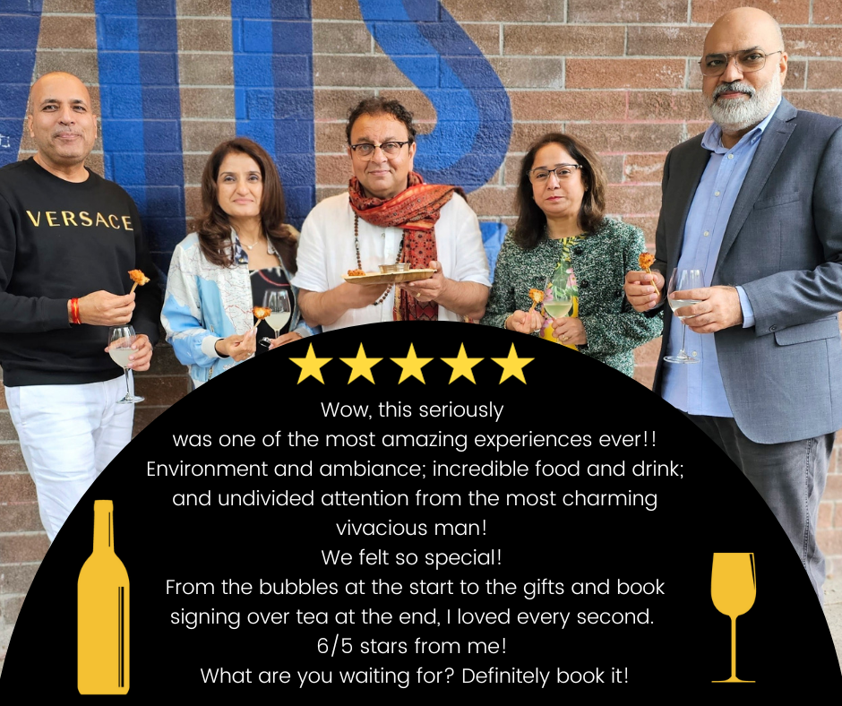 four guests with Chef Vikram Vij in front of the partial sign for Vij's, the restaurant in Vancouver. Chef Vikram is holding a tray and each guest has some street food on a skewer in one hand and a glass of bubbly in the other. Chef Vikram is in the middle with two guests on either side. There is a testimonial written across the front of the image with five stars across the top of the testimonial. The testimonial reads, "Wow, this seriously was one of the most amazing experiences ever!! Environment and ambiance; incredible food and drink; and undivided attention from the most charming vivacious man! We felt so special! From the bubbles at the start to the gifts and book signing over tea at the end, I loved every second.!! 6/5 stars from me! What are you waiting for? Definitely book it!